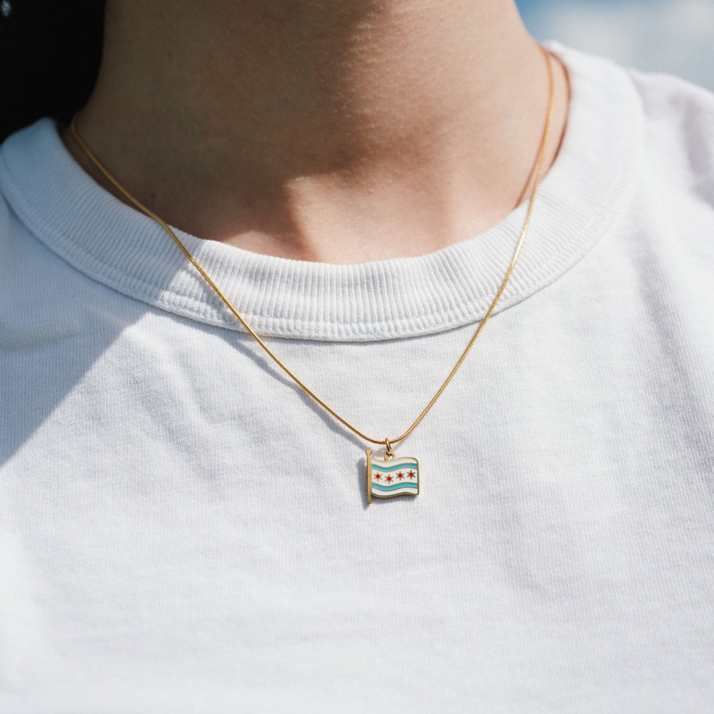 Necklace with a small pendant worn by a person on a white background