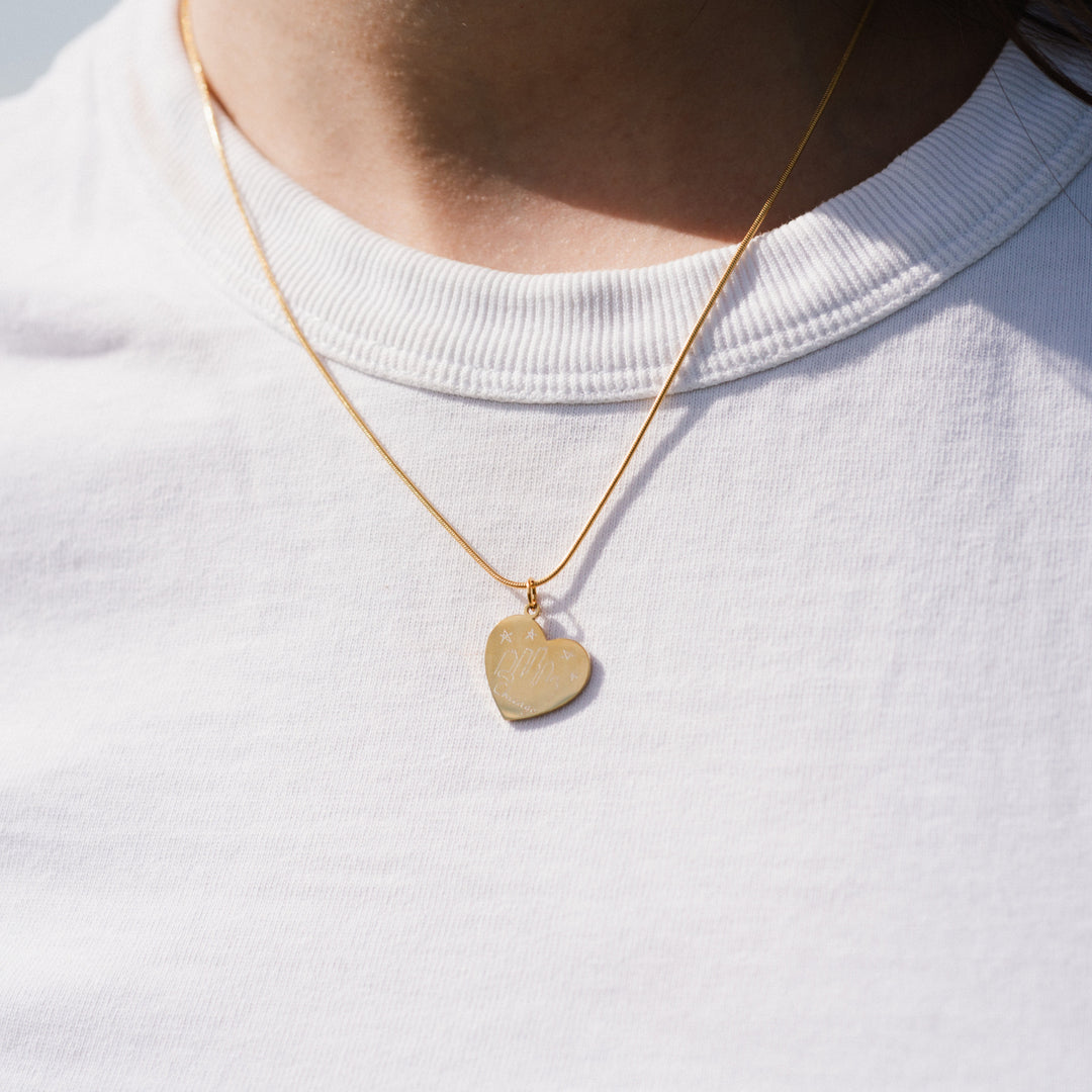 Gold heart-shaped pendant necklace on a white background