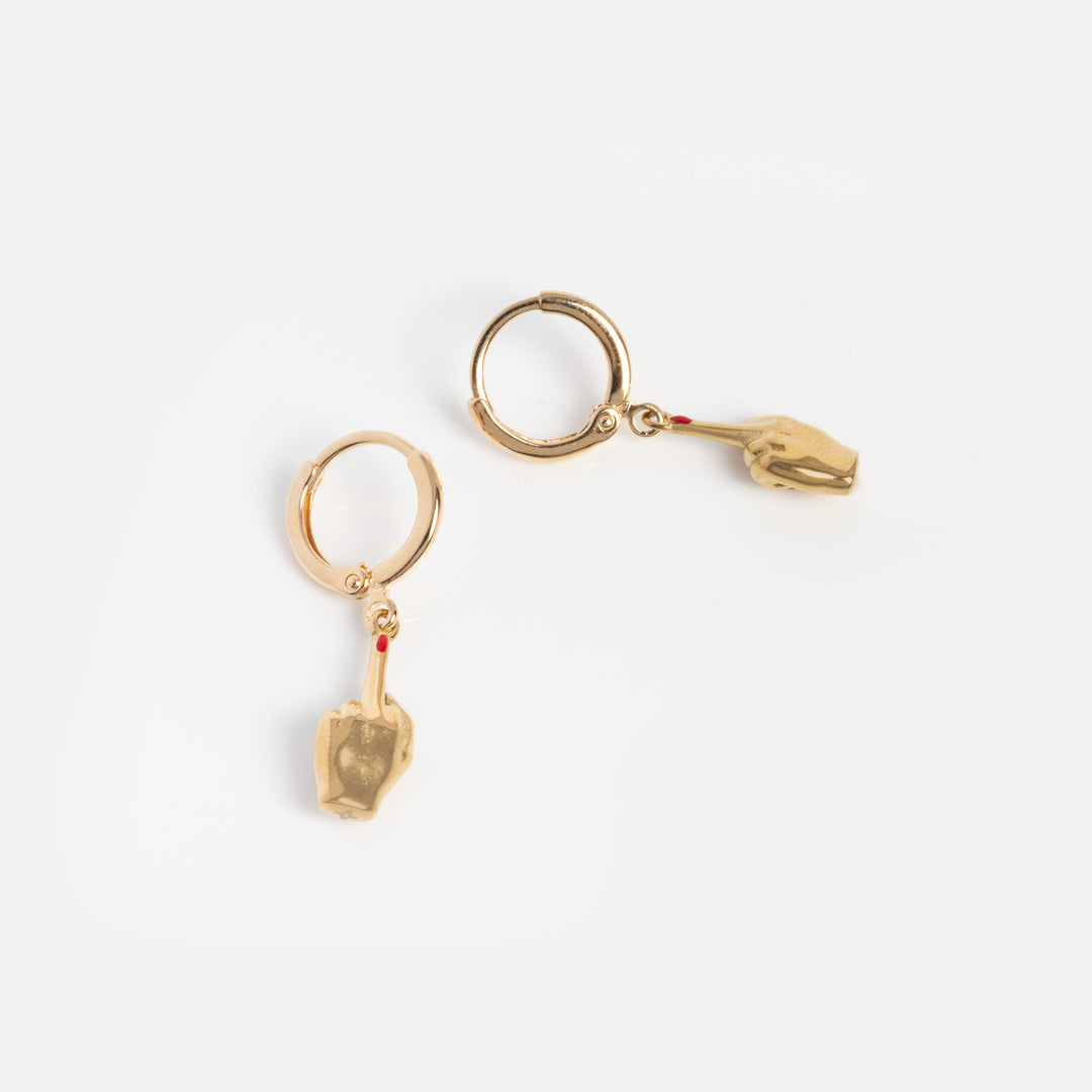Pair of gold hoop earrings with small animal charms on a white background