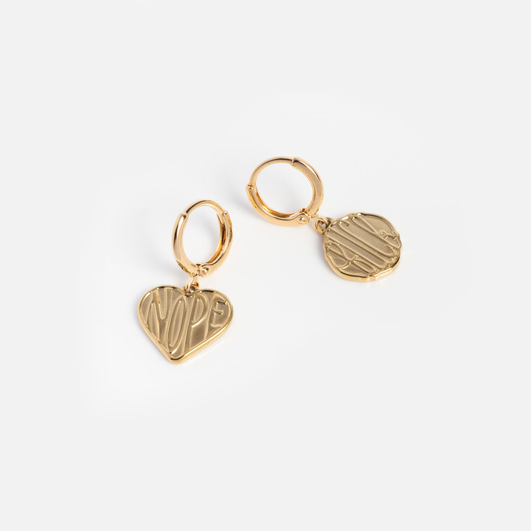 Gold hoop earrings with heart-shaped and round pendants on a white background