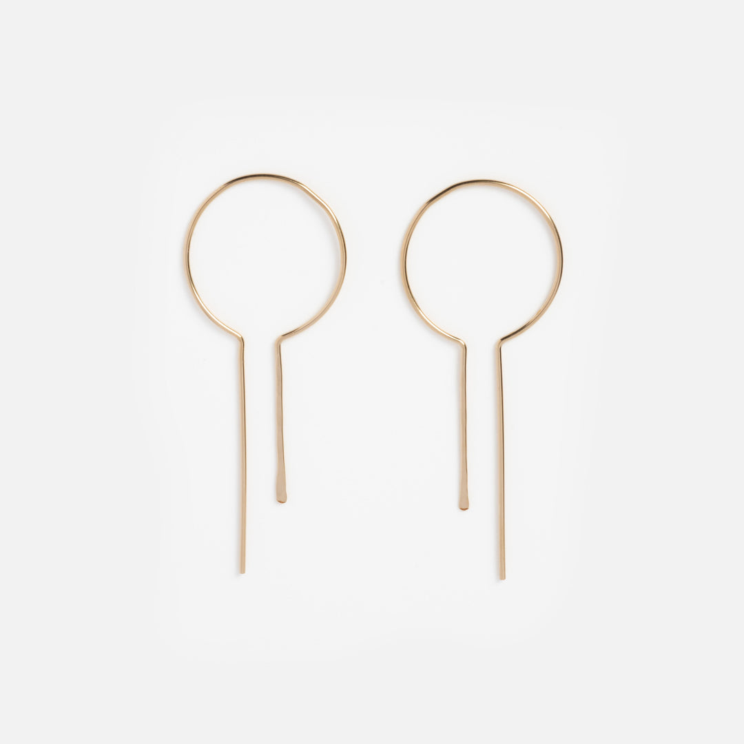 Pair of gold hoop earrings on a white background