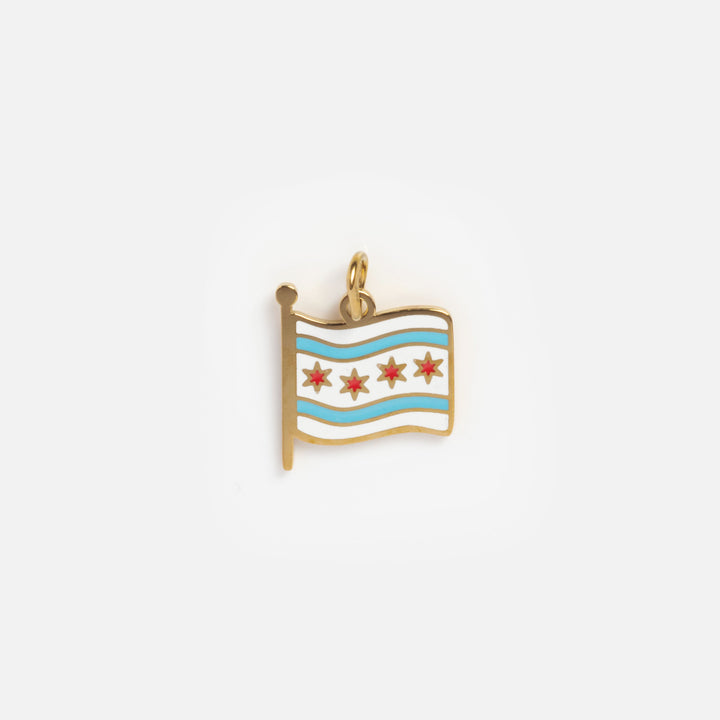 Gold charm with a flag design on a white background