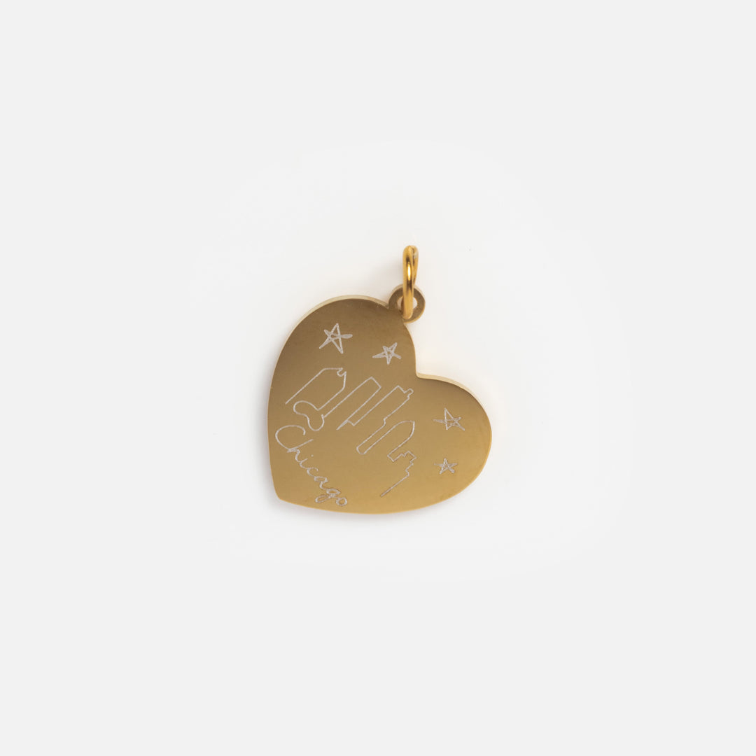 Gold heart-shaped pendant with engraved text on a white background