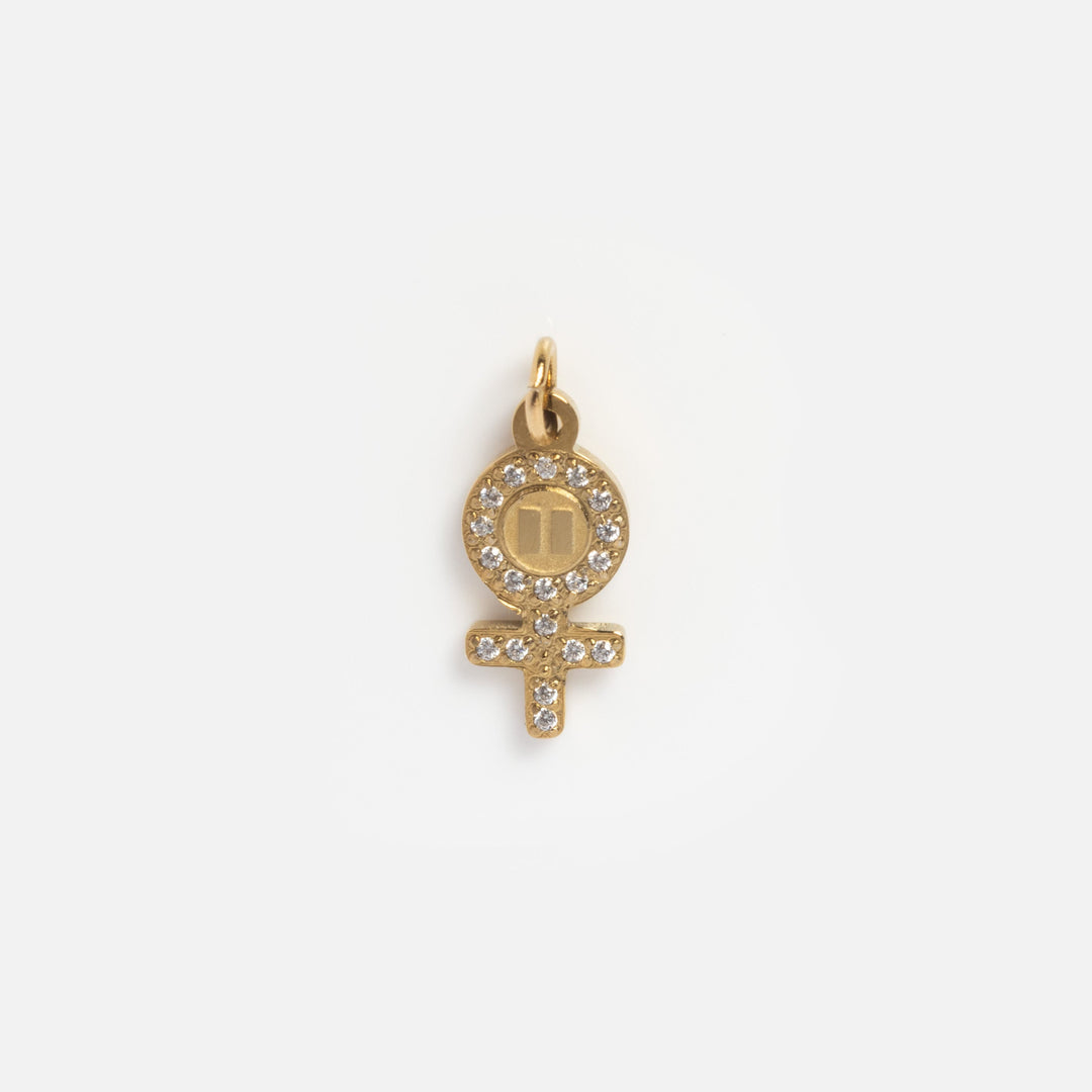 Gold pendant with a symbol on a white background