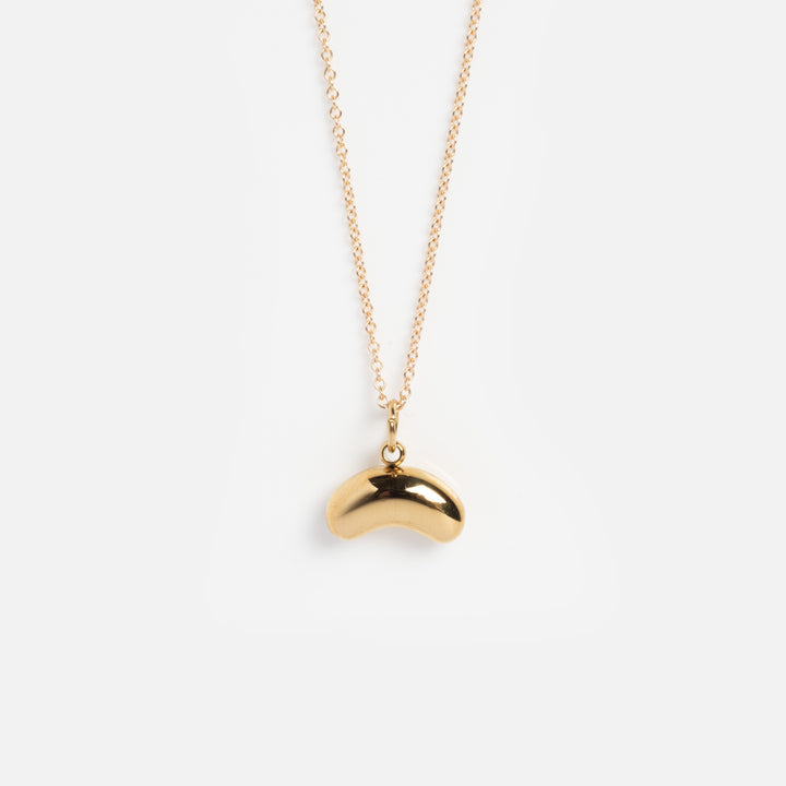 Gold necklace with a crescent moon pendant on a white background