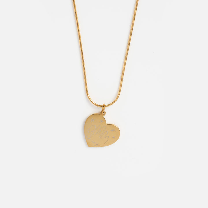 Gold heart-shaped pendant necklace on a white background