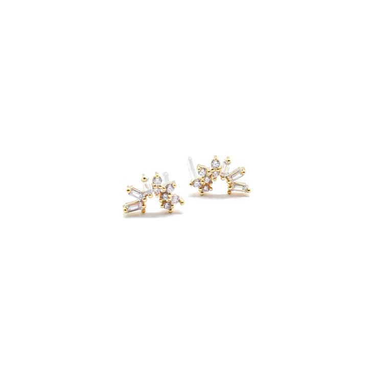 Gold earrings with clear stones on a white background