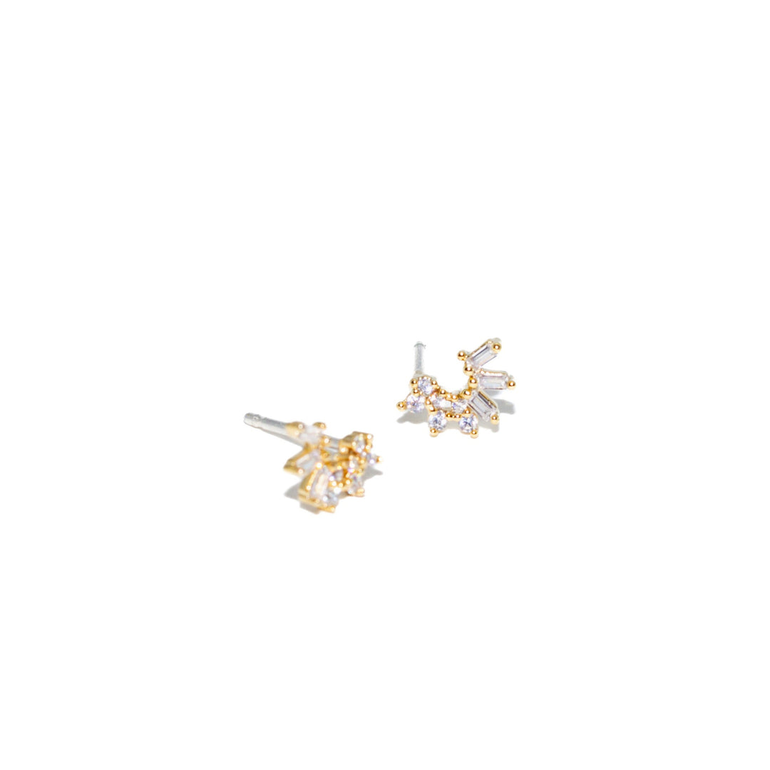 Pair of gold and silver earrings on a white background