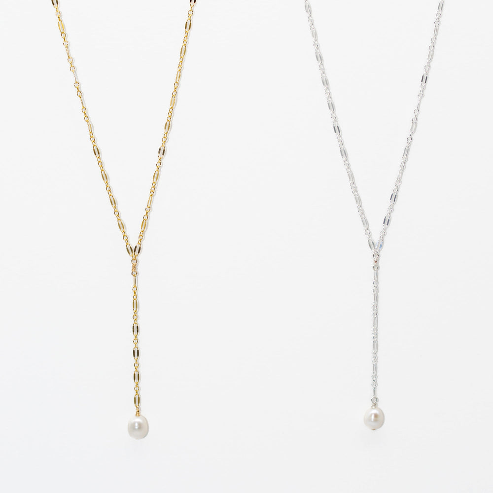 Two pearl necklaces, one gold and one silver, on a white background.