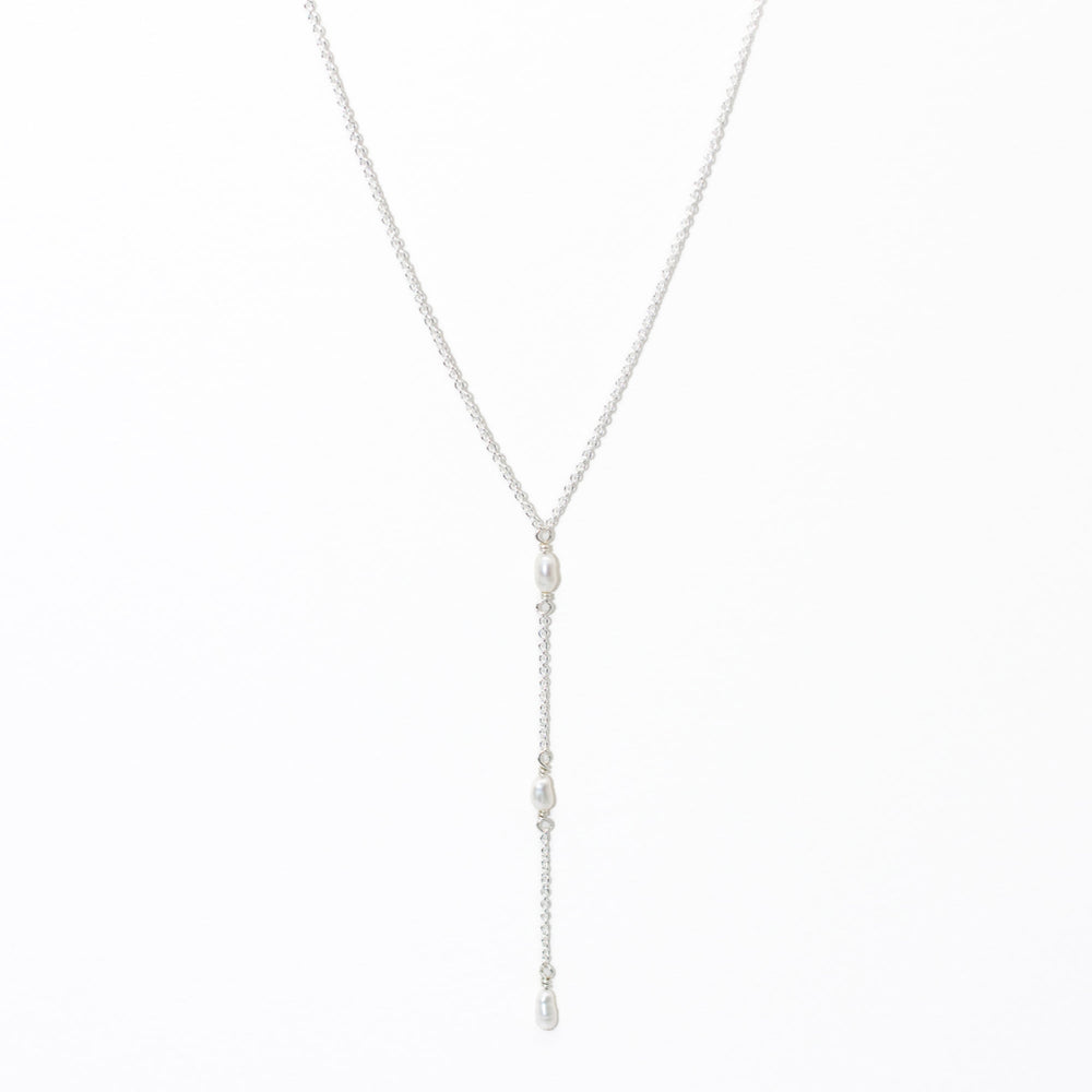 Silver necklace with pearl drops on a white background
