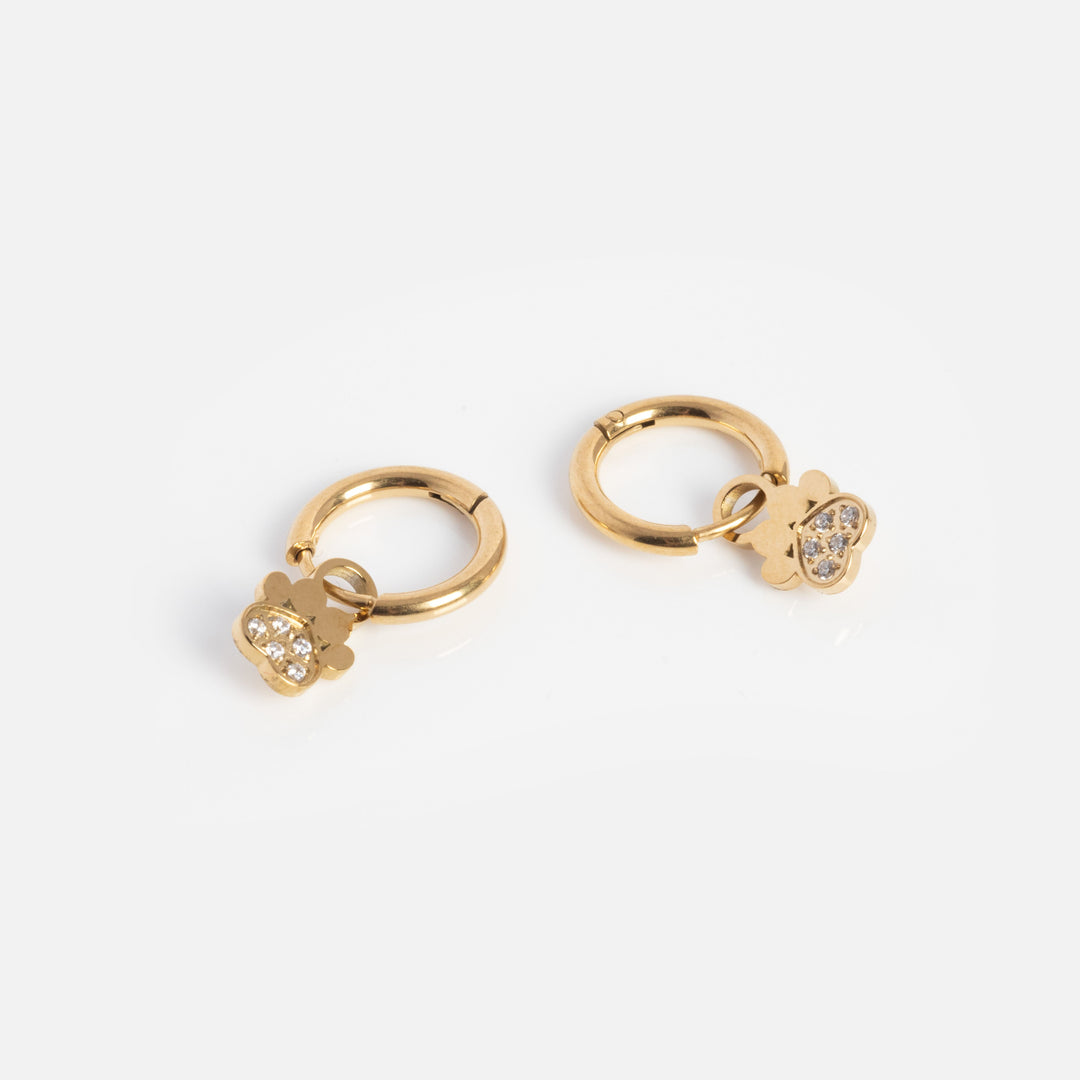 Gold hoop earrings with heart-shaped charms on a white background