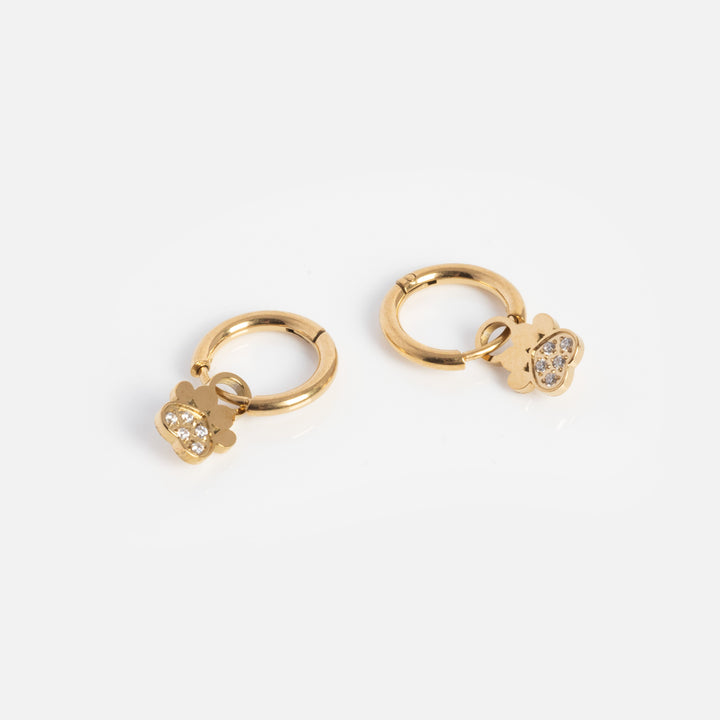 Gold hoop earrings with heart-shaped charms on a white background