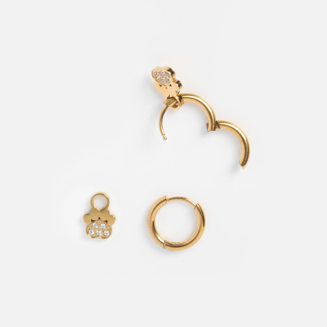 Set of gold hoop earrings on a white background