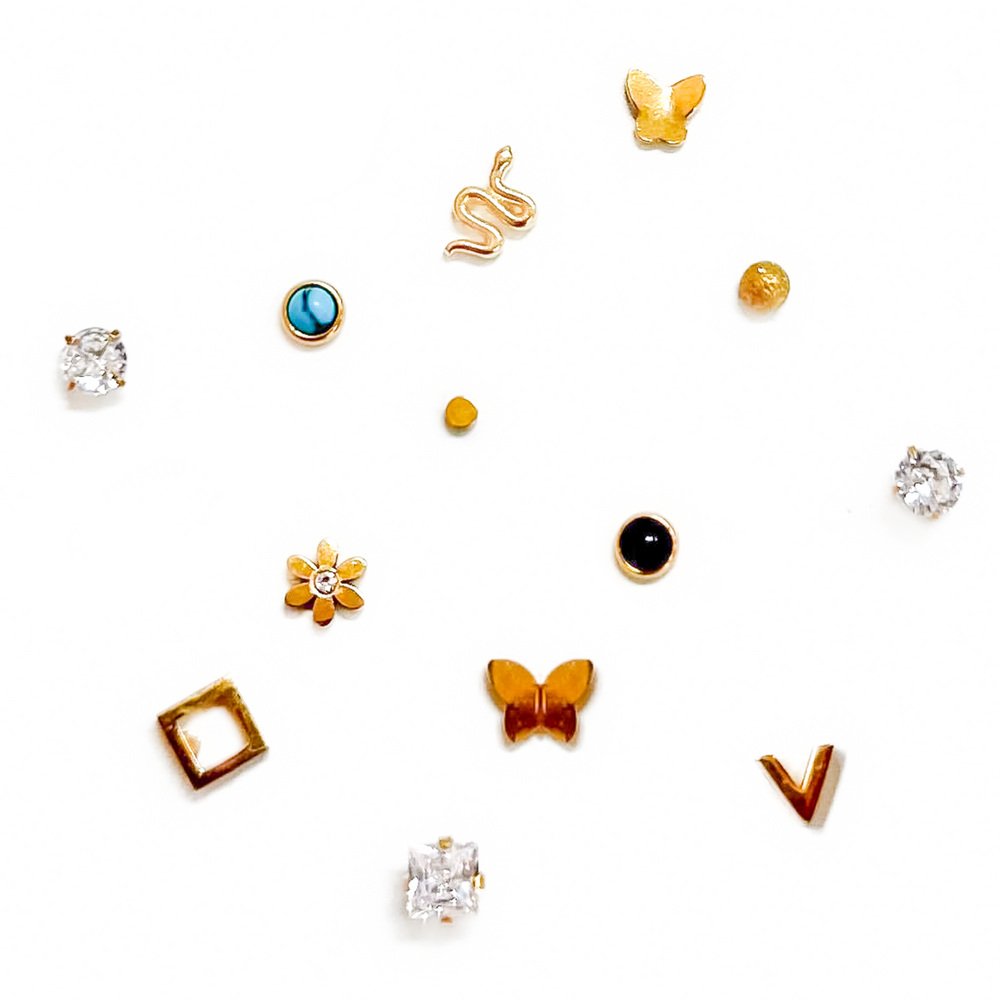 Collection of various small earrings on a white background